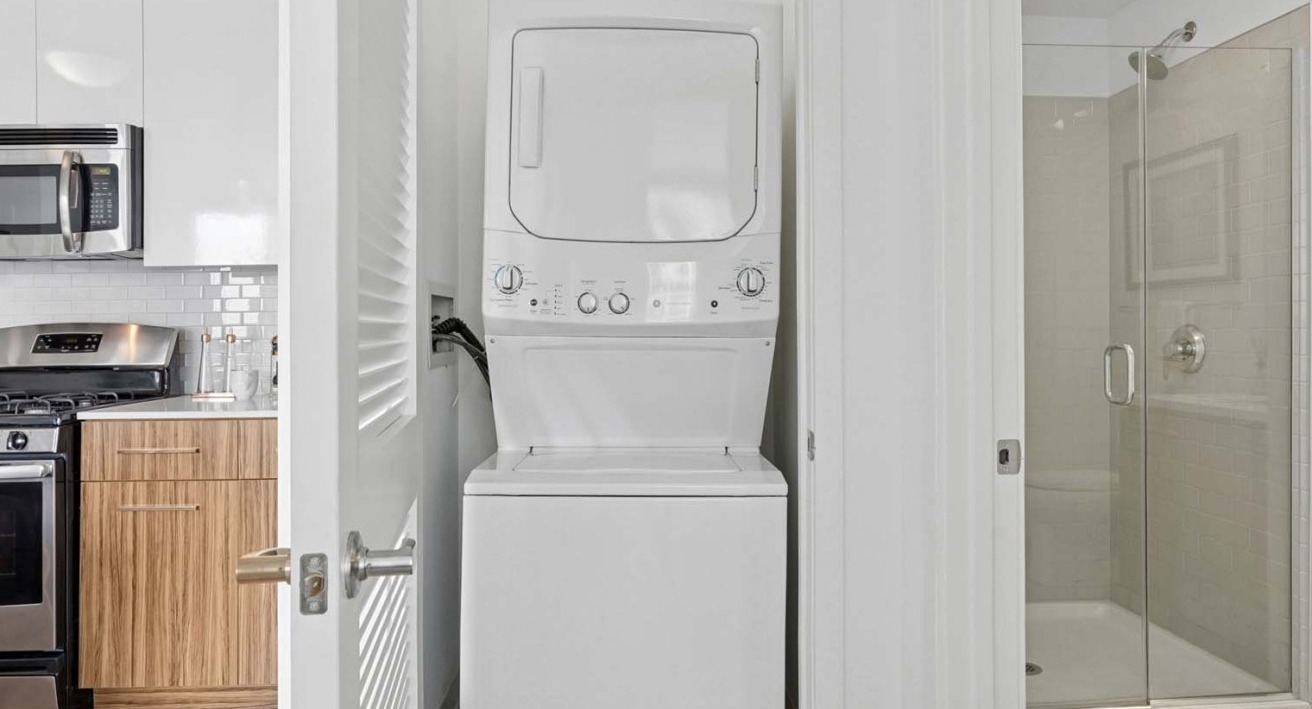 In-unit washer and dryer inside Wolf Point West apartments in Chicago with modern finishes and easy access